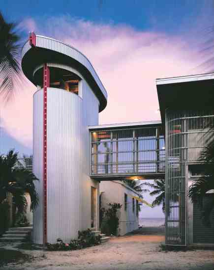 
A Florida Keys home uses vertical design for natural cooling and sturdy concrete and steel to protect against ocean storms and hurricanes.
